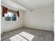 Bright bedroom featuring neutral walls, cozy carpet, and a window for natural light at 7964 S Rome Ct, Aurora, CO 80016