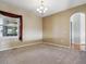 Cozy living room featuring plush carpeting, neutral paint, and abundant natural light at 7964 S Rome Ct, Aurora, CO 80016