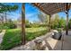 Inviting backyard space featuring a pergola, shaded seating area, and spacious grassy area at 1047 Scranton St, Aurora, CO 80011