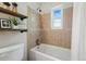 Well-lit bathroom with updated tile, shower and tub combination, offering a relaxing space to unwind at 1047 Scranton St, Aurora, CO 80011