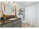 Bathroom featuring granite vanity, neutral shower, and updated fixtures at 1047 Scranton St, Aurora, CO 80011