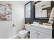 Bathroom features a white vanity, modern toilet, and decorative dark blue accent wall at 1047 Scranton St, Aurora, CO 80011