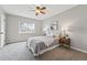 Cozy bedroom with neutral walls, plush carpet, ceiling fan, and ample natural light from the window at 1047 Scranton St, Aurora, CO 80011