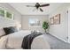 Bright bedroom features two windows, a ceiling fan, and neutral colored carpet at 1047 Scranton St, Aurora, CO 80011