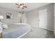Bright bedroom with plush carpet, ceiling fan, white walls, and a view into the ensuite at 1047 Scranton St, Aurora, CO 80011
