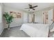 Bright bedroom with ceiling fan, neutral carpet, and en-suite bathroom at 1047 Scranton St, Aurora, CO 80011