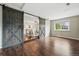 Spacious bonus room features sliding barn doors, hardwood floors, and great natural light, ideal for entertaining at 1047 Scranton St, Aurora, CO 80011