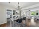 Charming dining room with modern lighting adjacent to the kitchen and living room providing ample space for dining at 1047 Scranton St, Aurora, CO 80011