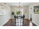 Stylish dining room featuring modern lighting, wood floors, and sliding glass doors at 1047 Scranton St, Aurora, CO 80011