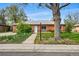 Charming brick home with mature trees, lush landscaping, and a welcoming entrance at 1047 Scranton St, Aurora, CO 80011