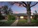 Charming brick home features a mature tree, well-maintained landscaping, and inviting front walkway at 1047 Scranton St, Aurora, CO 80011