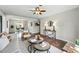 Bright and airy living room with hardwood floors and open layout to dining area at 1047 Scranton St, Aurora, CO 80011