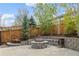 Backyard includes a stone fire pit and seating at 6827 Leilani Ln, Castle Rock, CO 80108