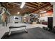Finished basement features open ceiling, workout area and shelving at 6827 Leilani Ln, Castle Rock, CO 80108