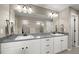 Bright bathroom featuring dual sinks, modern vanity, and glass-enclosed shower at 6827 Leilani Ln, Castle Rock, CO 80108