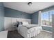 Stylish bedroom with a comfortable bed, modern decor, and a large window at 6827 Leilani Ln, Castle Rock, CO 80108