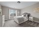 Neutral bedroom featuring a comfortable bed, large window, and classic decor at 6827 Leilani Ln, Castle Rock, CO 80108