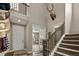 A beautiful two-story foyer with wood floors, staircase, and natural light at 6827 Leilani Ln, Castle Rock, CO 80108