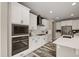 Well-equipped kitchen with stainless steel appliances, white cabinetry, and a modern backsplash at 6827 Leilani Ln, Castle Rock, CO 80108