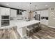 Modern kitchen with white cabinets, stainless steel appliances, a large center island, and stylish pendant lighting at 6827 Leilani Ln, Castle Rock, CO 80108