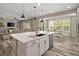 Bright open-concept kitchen with a large island, pendant lighting, and views of the dining area and living room at 6827 Leilani Ln, Castle Rock, CO 80108