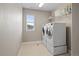 Functional laundry room with modern washer and dryer set and storage at 6827 Leilani Ln, Castle Rock, CO 80108