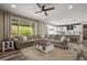 Spacious living room with comfortable seating and open layout to kitchen at 6827 Leilani Ln, Castle Rock, CO 80108