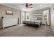 Spacious main bedroom with a king-size bed, dresser, and ample natural light from multiple windows at 6827 Leilani Ln, Castle Rock, CO 80108