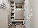 Organized mudroom featuring a bench, storage cubbies, coat hooks and welcome sign at 6827 Leilani Ln, Castle Rock, CO 80108