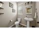 Well-lit powder room with stylish sink, mirror, and modern fixtures at 6827 Leilani Ln, Castle Rock, CO 80108