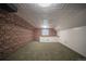 Basement featuring exposed brick wall, carpet and bright ceiling at 814 Rose St, Georgetown, CO 80444