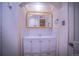 Bathroom with double sinks, storage cabinets, and a mirrored medicine cabinet at 814 Rose St, Georgetown, CO 80444