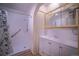 Bathroom with a walk-in shower, white vanity, and mirrored medicine cabinet at 814 Rose St, Georgetown, CO 80444