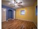 Bright bedroom with hardwood floors, ceiling fan, and fresh wall colors at 814 Rose St, Georgetown, CO 80444