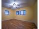 Cozy bedroom with wood floors and two windows providing natural light at 814 Rose St, Georgetown, CO 80444
