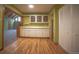 Dining area with hardwood floors, white cabinets, and open access to other rooms at 814 Rose St, Georgetown, CO 80444