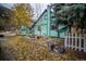 Exterior view of the home showcasing unique architecture, green siding and colorful trim at 814 Rose St, Georgetown, CO 80444