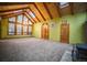 Bright living room featuring skylights, wood beamed ceilings and wood burning stove at 814 Rose St, Georgetown, CO 80444