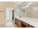 Bright bathroom with a long vanity, tiled floors, glass block decor, and a separate water closet at 7720 W Quincy Dr, Lakewood, CO 80235