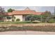 Charming home featuring a unique terracotta tiled roof and well-maintained front yard landscaping at 7720 W Quincy Dr, Lakewood, CO 80235