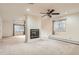 Large living room with a fireplace and windows that bring in natural light at 7720 W Quincy Dr, Lakewood, CO 80235