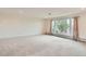 Spacious living room with a large window that brings in natural light and wall to wall carpeting at 7720 W Quincy Dr, Lakewood, CO 80235