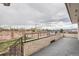 Open patio featuring a low brick retaining wall with mountain and city views at 7720 W Quincy Dr, Lakewood, CO 80235