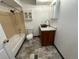 This bathroom features a sink with a cabinet, toilet, shower, and bathtub with tile and updated fixtures at 992 S Dearborn Way # 7, Aurora, CO 80012
