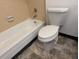 This bathroom features a bathtub with a shower and a toilet, and a light and bright interior at 992 S Dearborn Way # 7, Aurora, CO 80012
