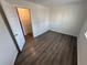 This is an empty bedroom that features dark wood flooring and a large window that provides natural light at 992 S Dearborn Way # 7, Aurora, CO 80012