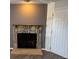Living room fireplace with stone surround and wood mantel at 992 S Dearborn Way # 7, Aurora, CO 80012
