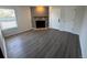 A bright living room featuring neutral paint, stone fireplace, and modern wood floors at 992 S Dearborn Way # 7, Aurora, CO 80012