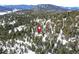 Aerial view showing location of house in snowy wooded mountain area at 8919 Hillview Rd, Morrison, CO 80465