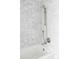Bathroom features a white tub and shower with a marble-look tile surround at 1750 Wewatta St # 740, Denver, CO 80202